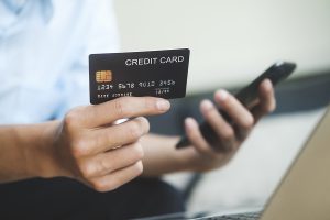 Young asian business hands holding credit card and using laptop smart phone Online shopping Website. Easy Ecommerce Website Shop Online by Smartphone.Online shopping concept.
