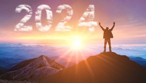 2024. New Year 2024, New Start motivation inspirational quote message on silhouette of winner man in sunset with arms up in happiness. Welcome Happy new year in 2024